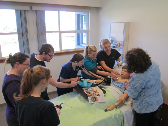 nursing students work with a human patient simulator