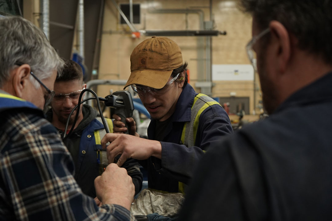 Trades instructors interacting with students