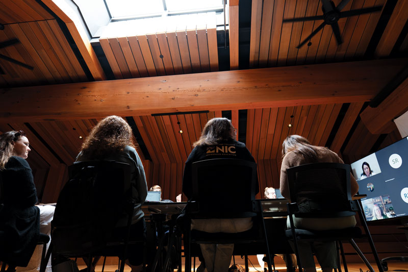 NIC's Indigenous Education working group sits at a table at the Campbell River Indigenous gathering place, with Health and Human Services department