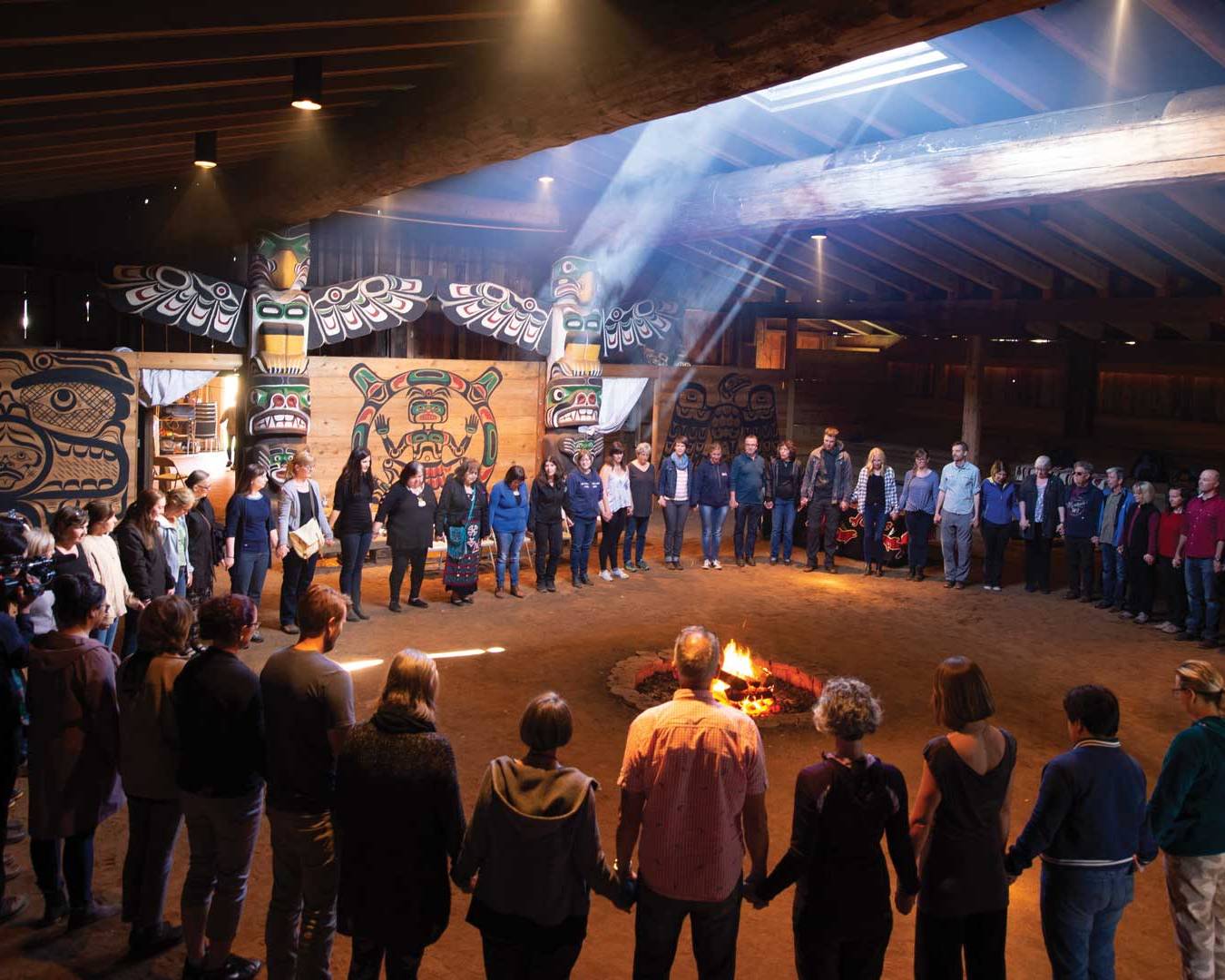 A group of NIC staff members attend a cultural sharing event at the K'ómoks First Nation.