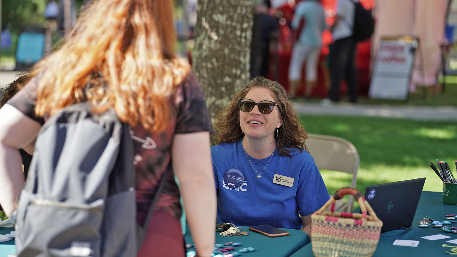 A college representative answers a student question at orientation