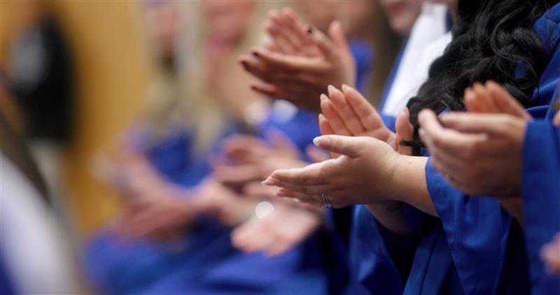 hands of graduates applauding