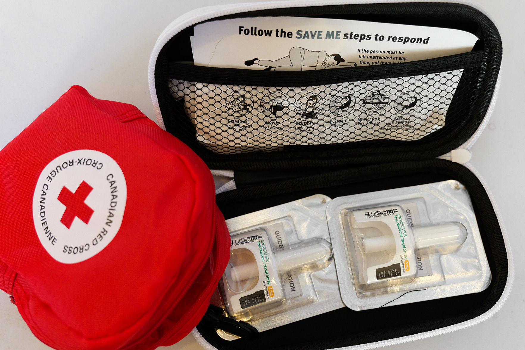 An open naloxone kit with NARCAN nasal spray