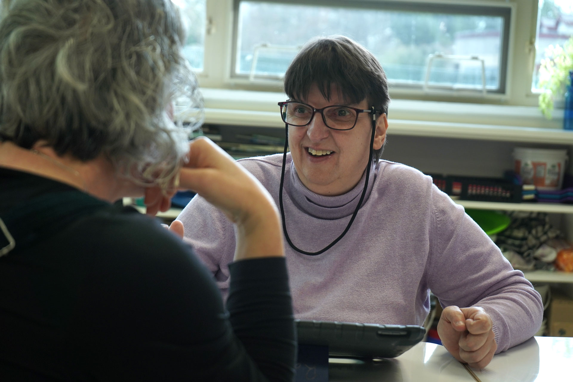 AET Instructor works with a student in the classroom