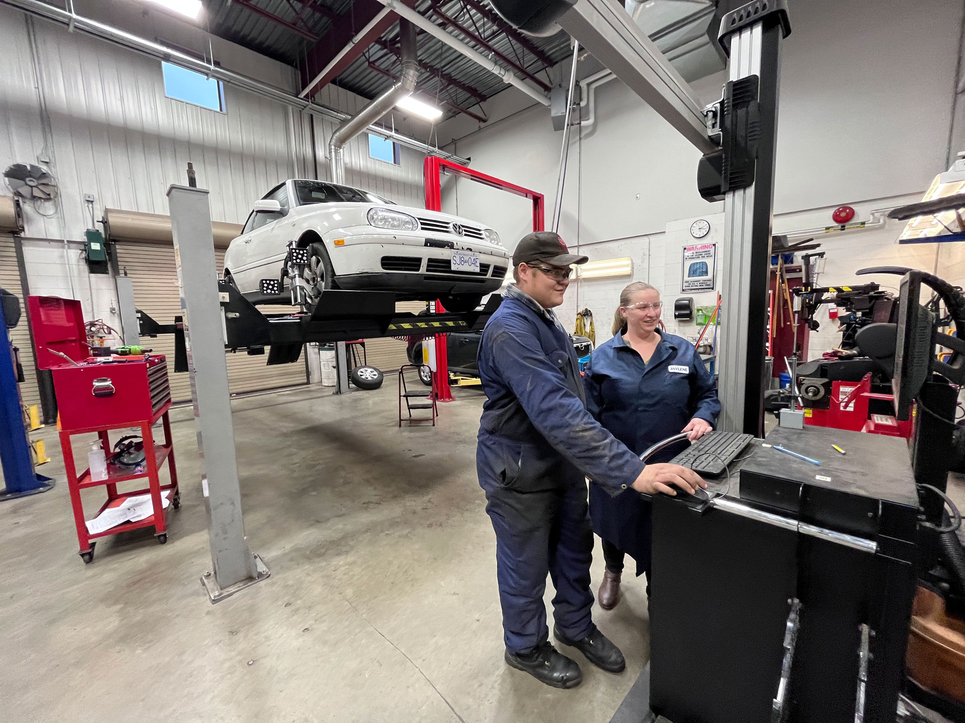 NIC Automotive instructor, Jaylene Van Der Merwe teaching in the Campbell River Campus automotive shop