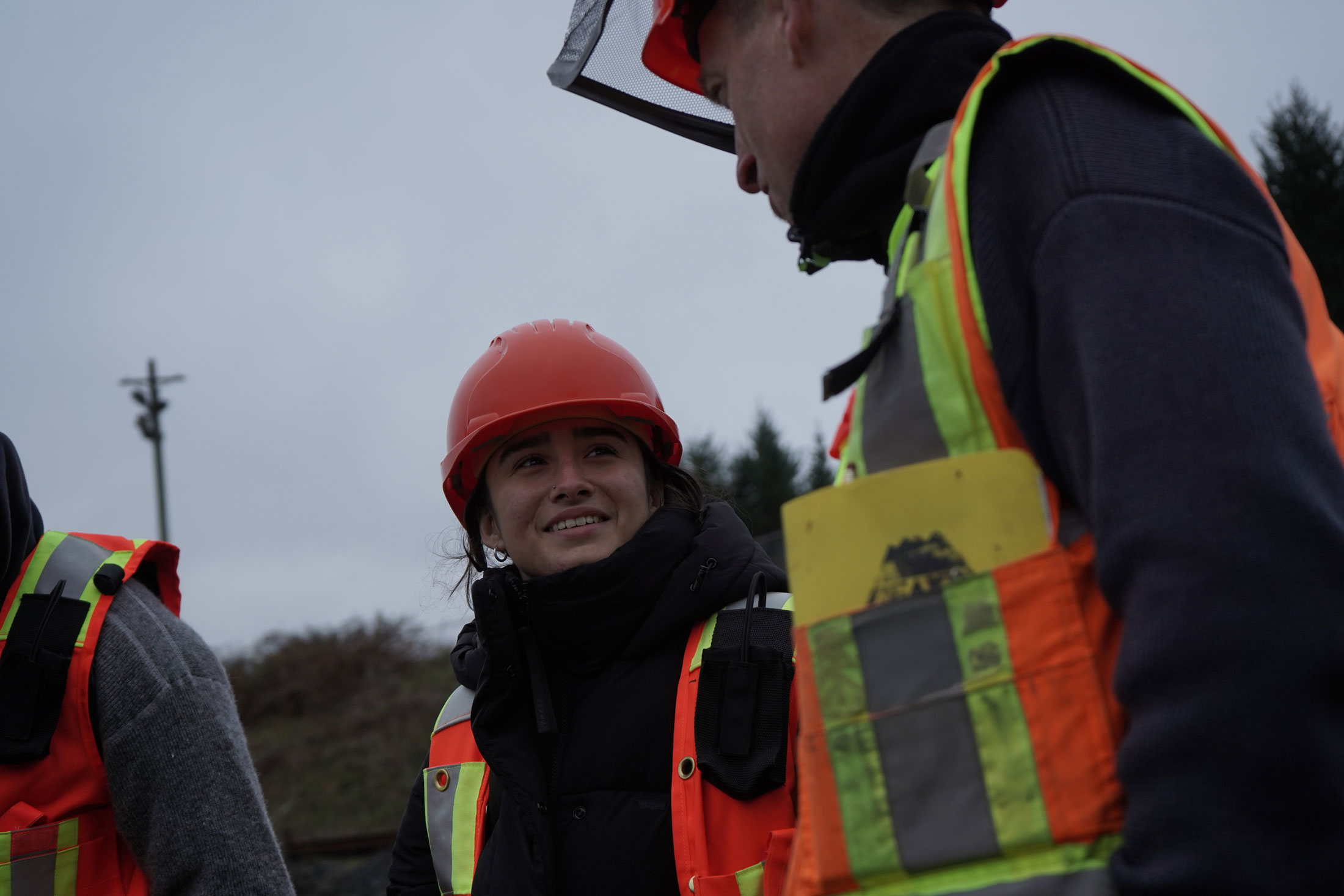 NIC Student on a Coastal Forestry job site wearing a high-vis vest and hard hat