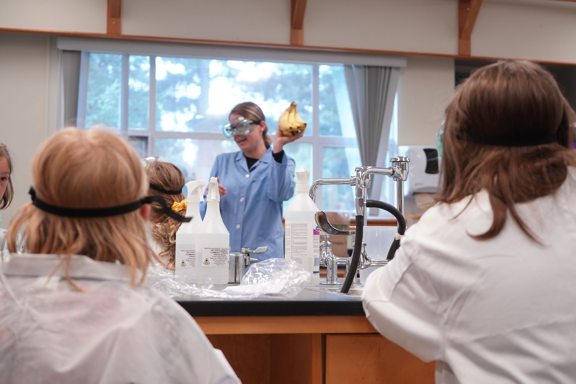 Youth Academy Summer Camp STEM participant in a science lab wearing PPE
