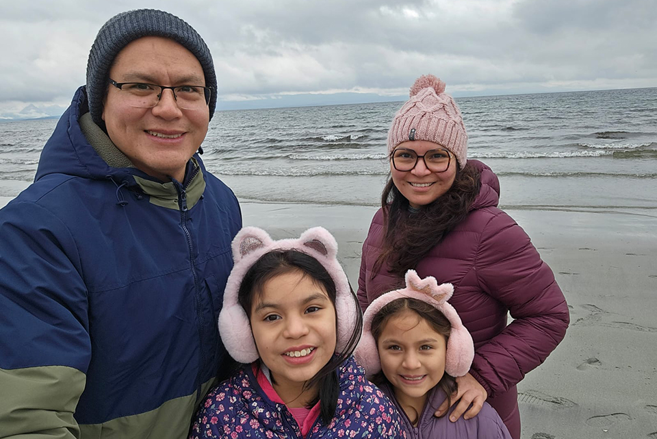 Family of four on the beach on an overcast day